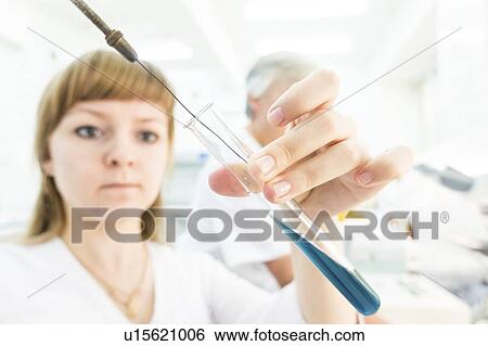 Stock Photograph - Biological research. Technician with solution.. Fotosearch