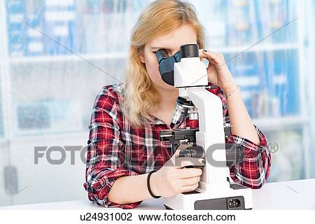 Biology lesson. Student using a light microscope. View Large Photo Image Stock Image - Biology lesson. Student using a light microscope.. Fotosearch