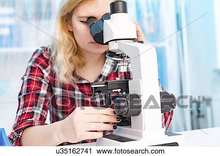 Biology lesson. Student using a light microscope. View Large Photo Image Stock Image - Biology lesson. Student using a light microscope.. Fotosearch