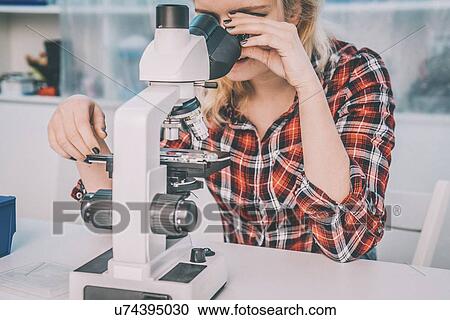 Biology lesson. Student using a light microscope. View Large Photo Image Stock Image - Biology lesson. Student using a light microscope.. Fotosearch