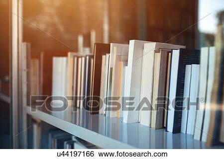 Books on library shelf through window. View Large Photo Image Stock Photograph - Books on library shelf through window.. Fotosearch