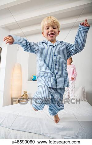 Boy and female twin jumping from bed View Large Photo Image Stock Image - Boy and female twin jumping from bed. Fotosearch