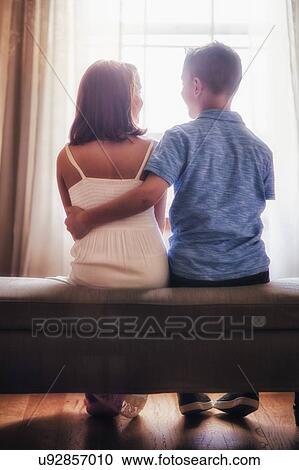 Boy and girl, sitting in front of window, rear view View Large Photo Image Stock Image - Boy and girl, sitting in front of window, rear view. Fotosearch