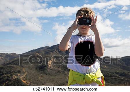 Boy exploring with camera in hills, Thousand Oaks, California, US View Large Photo Image Stock Image - Boy exploring with camera in hills, Thousand Oaks, California, US. Fotosearch