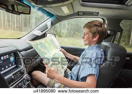 Boy on road trip reading map View Large Photo Image Stock Image - Boy on road trip reading map. Fotosearch