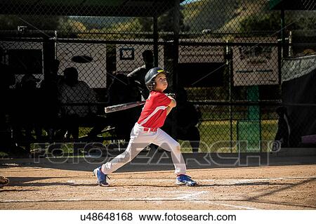 Stock Photo - Boy playing baseball. Fotosearch