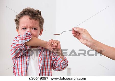 Boy refusing to take medication View Large Photo Image Stock Photo - Boy refusing to take medication. Fotosearch