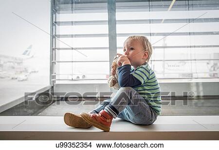 Boy sitting beside window View Large Photo Image Picture - Boy sitting beside window. Fotosearch
