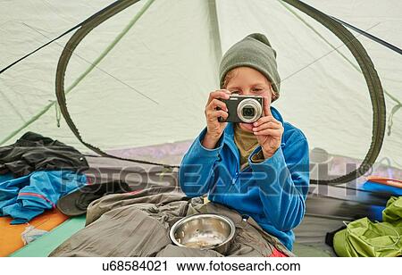 Boy sitting in tent, looking at camera, Ventilla, La Paz, Bolivia, South America View Large Photo Image Stock Image - Boy sitting in tent, looking at camera, Ventilla, La Paz, Bolivia, South America. Fotosearch