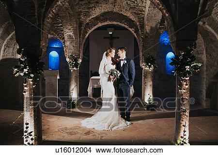 Bride and bridegroom getting married in church View Large Photo Image Picture - Bride and bridegroom getting married in church. Fotosearch