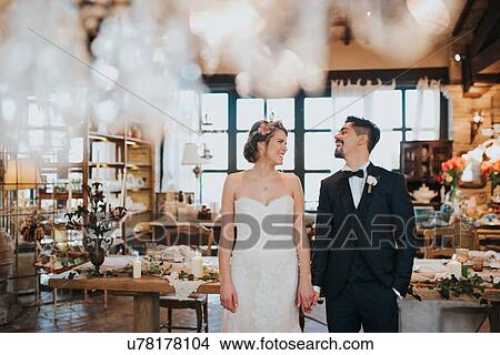 Picture - Bride and bridegroom in dining room of wedding reception. Fotosearch