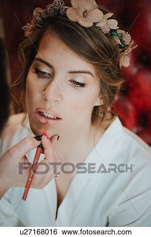 Stock Photograph - Bride having lipliner applied by make-up artist. Fotosearch