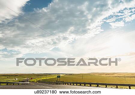 Bright cloudscape over flat rural landscape, Montana, US View Large Photo Image Stock Image - Bright cloudscape over flat rural landscape, Montana, US. Fotosearch