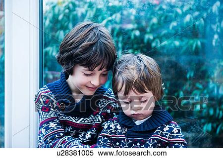 Stock Photography - Brothers by patio door. Fotosearch