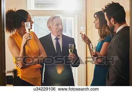 Stock Photograph - Business team drinking champagne at office celebration. Fotosearch