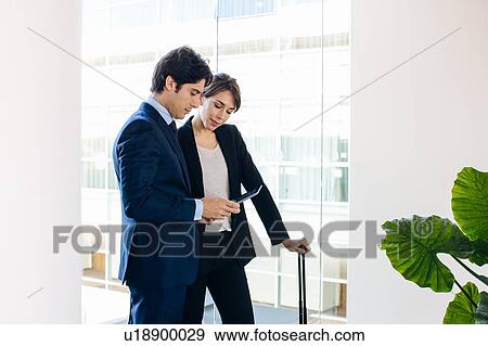 Businessman and businesswoman using digital tablet View Large Photo Image Stock Photo - Businessman and businesswoman using digital tablet. Fotosearch