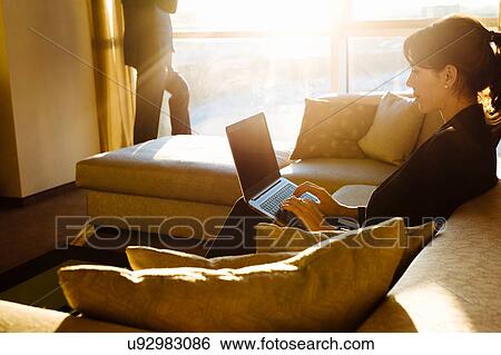 Businessman and businesswoman working in hotel bedroom View Large Photo Image Stock Photograph - Businessman and businesswoman working in hotel bedroom. Fotosearch