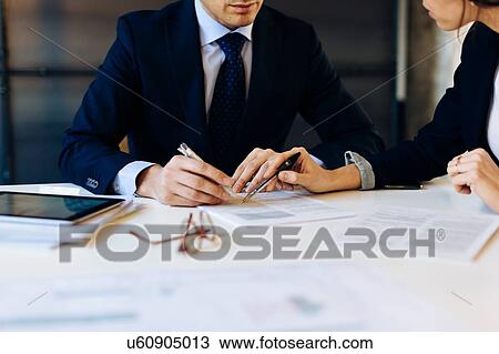 Businessman and woman in meeting, mid section View Large Photo Image Stock Image - Businessman and woman in meeting, mid section. Fotosearch