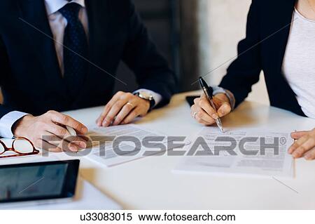 Businessman and woman in meeting, signing documents, mid section View Large Photo Image Stock Photography - Businessman and woman in meeting, signing documents, mid section. Fotosearch