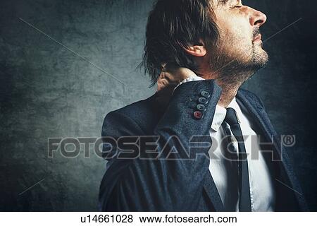 Stock Photo - Businessman with neck pain.. Fotosearch