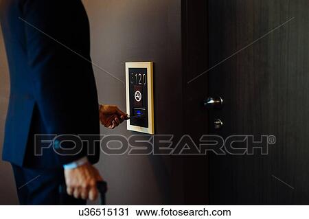 Businessman with wheeled luggage entering hotel bedroom View Large Photo Image Stock Image - Businessman with wheeled luggage entering hotel bedroom. Fotosearch