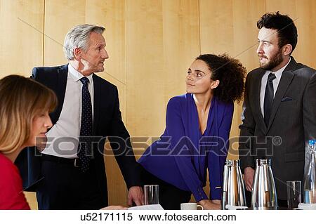 Businessmen and women having discussion at office meeting View Large Photo Image Stock Photography - Businessmen and women having discussion at office meeting. Fotosearch