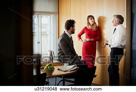 Businesswoman and men having office meeting View Large Photo Image Stock Photo - Businesswoman and men having office meeting. Fotosearch