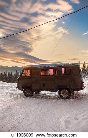 Stock Photo - Camper van on covered landscape at sunset, Gurne, Ukraine, Eastern Europe. Fotosearch