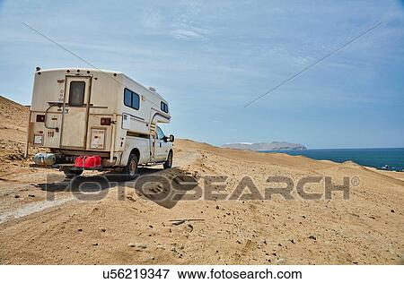 Stock Photo - Campervan on sandy track along coast, Laguna Grande, Ica, Peru. Fotosearch