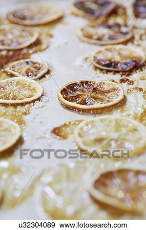 Stock Photo - Caramelized lemons on parchment paper. Fotosearch