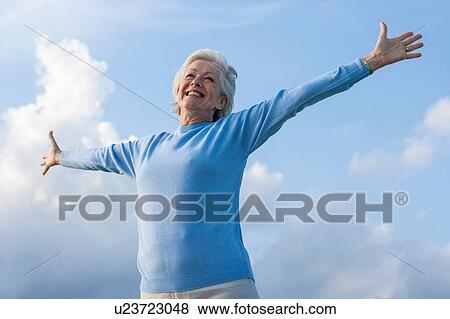 Stock Photo - Carefree woman with arms open. Fotosearch