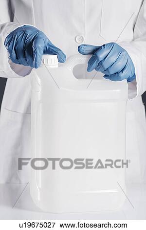 Stock Photo - Chemist opening white plastic canister.. Fotosearch