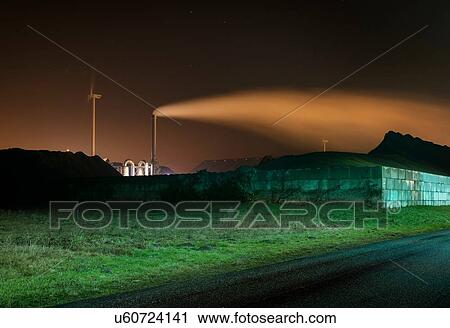 Stock Image - Chimney, wind turbine and coal in Eemshaven harbour area, Delfzijl, Groningen, Netherlands. Fotosearch
