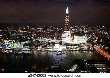 Stock Image - Cityscape of London and river Thames illuminated at night, United Kingdom, Europe. Fotosearch