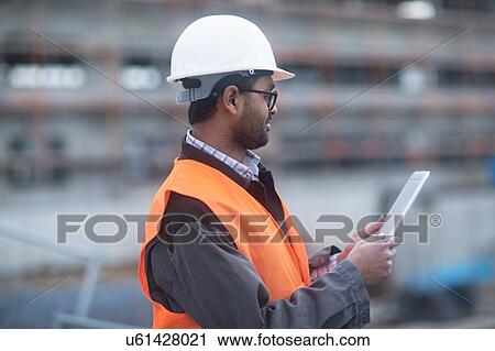 Civil engineer working at site View Large Photo Image Stock Image - Civil engineer working at site. Fotosearch