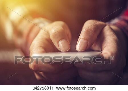 Close up of hands using mobile phone. View Large Photo Image Stock Image - Close up of hands using mobile phone.. Fotosearch