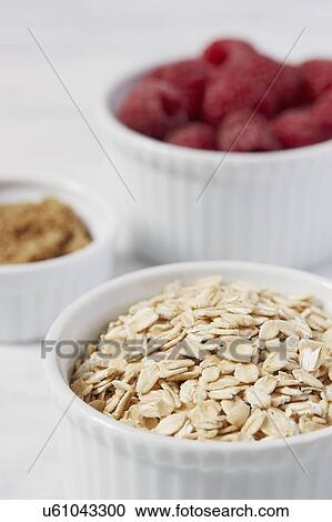 Close up of oats and raspberries in bowls View Large Photo Image Stock Image - Close up of oats and raspberries in bowls. Fotosearch