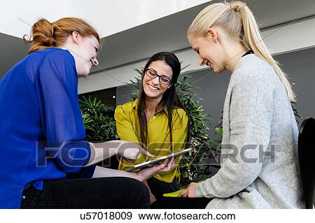 Colleagues having meeting using digital tablet View Large Photo Image Stock Photo - Colleagues having meeting using digital tablet. Fotosearch