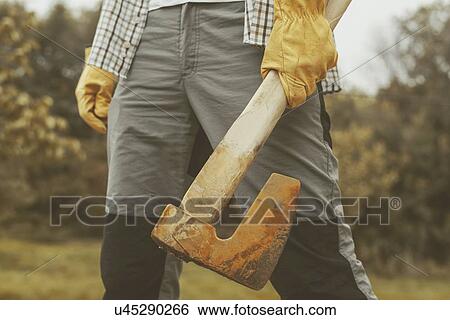 Stock Photograph - Confident lumberjack with axe.. Fotosearch