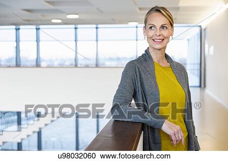 Confident mature businesswoman in office atrium View Large Photo Image Stock Image - Confident mature businesswoman in office atrium. Fotosearch