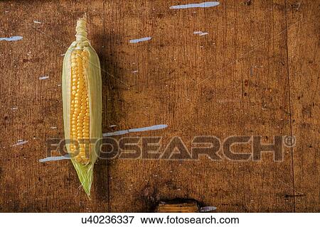 Corn cob on rustic wooden table. View Large Photo Image Stock Photo - Corn cob on rustic wooden table.. Fotosearch