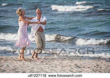 Stock Photo - Couple dancing on beach, Palma de Mallorca, Spain. Fotosearch