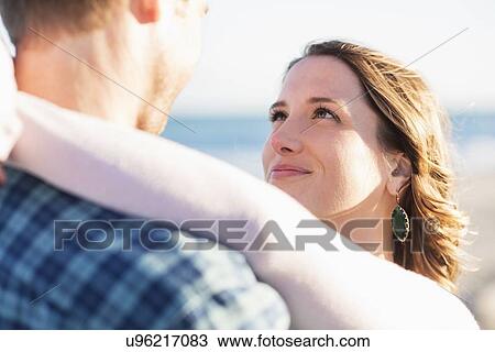 Couple embracing in beach View Large Photo Image Stock Image - Couple embracing in beach. Fotosearch