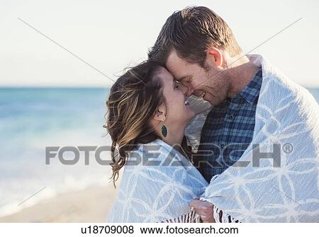 Stock Photo - Couple embracing on beach. Fotosearch