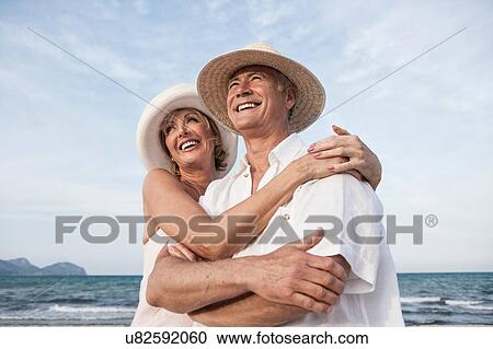 Stock Image - Couple hugging on beach, Palma de Mallorca, Spain. Fotosearch
