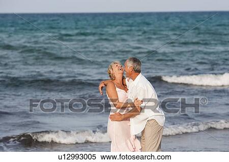 Couple hugging on beach, Palma de Mallorca, Spain View Large Photo Image Stock Photography - Couple hugging on beach, Palma de Mallorca, Spain. Fotosearch