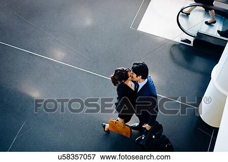 Stock Photo - Couple in business suits kissing. Fotosearch