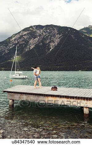 Couple on pier kissing, Achensee, Innsbruck, Tirol, Austria, Europe View Large Photo Image Stock Image - Couple on pier kissing, Achensee, Innsbruck, Tirol, Austria, Europe. Fotosearch