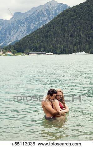 Couple waist deep in water hugging, Achensee, Innsbruck, Tirol, Austria, Europe View Large Photo Image Stock Photograph - Couple waist deep in water hugging, Achensee, Innsbruck, Tirol, Austria, Europe. Fotosearch
