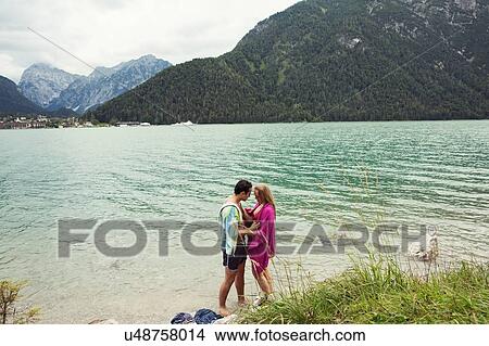 Picture - Couple wrapped in towel by Achensee, Innsbruck, Tirol, Austria, Europe. Fotosearch
